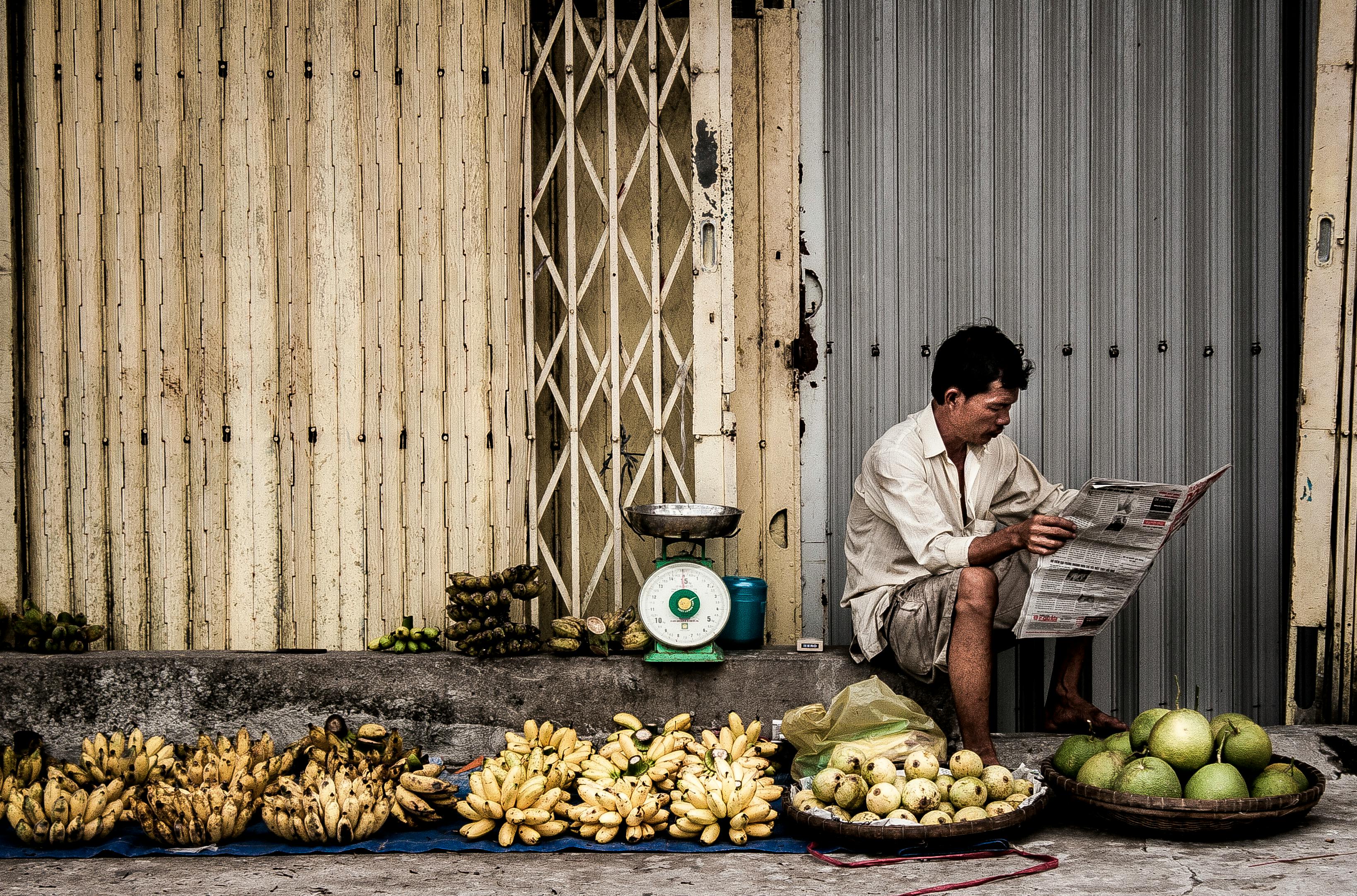 Man Sitting Near Fruits